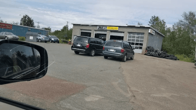P&T Auto Limited storefront on Earle Street with cars parked out front.