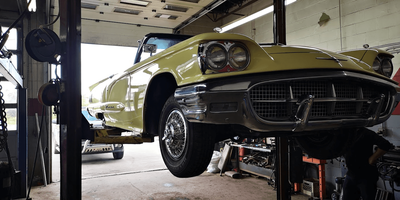 A late-1950s Ford Thunderbird up on the lift.