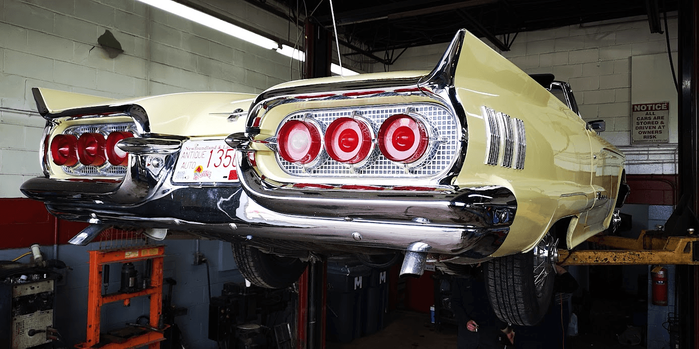 The chrome tail section of a Thunderbird under the lift lights.